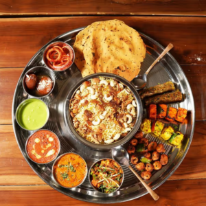 "A fragrant plate of biryani, with perfectly cooked rice, tender meat, and a blend of aromatic spices, garnished with fresh herbs and fried onions."
