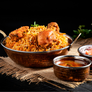 "A fragrant plate of biryani, with perfectly cooked rice, tender meat, and a blend of aromatic spices, garnished with fresh herbs and fried onions."