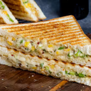 "A delicious sandwich filled with layers of fresh vegetables, meat, and cheese, all nestled between two slices of perfectly toasted bread."