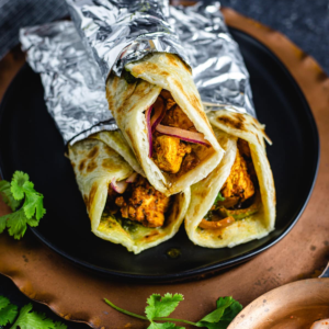 "Delicious Frankie wrap filled with spiced vegetables, grilled meat, and fresh toppings, all wrapped in a soft, warm flatbread."