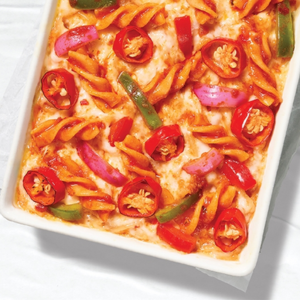 "A plate of creamy pasta topped with fresh herbs, grated cheese, and a rich sauce, served in a beautifully arranged dish."