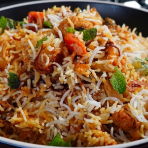 "A fragrant plate of biryani, with perfectly cooked rice, tender meat, and a blend of aromatic spices, garnished with fresh herbs and fried onions."