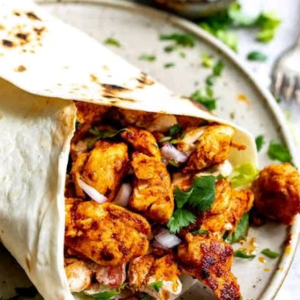 "Delicious Frankie wrap filled with spiced vegetables, grilled meat, and fresh toppings, all wrapped in a soft, warm flatbread."