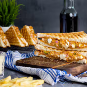 "A delicious sandwich filled with layers of fresh vegetables, meat, and cheese, all nestled between two slices of perfectly toasted bread."