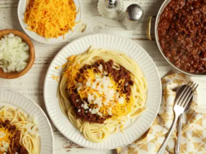 "A bowl of Skylike Chili, featuring a rich blend of savory meat, beans, and spices, topped with a sprinkle of cheese and fresh garnishes, served hot and ready to enjoy."