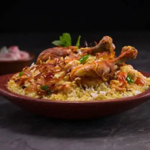 "A fragrant plate of biryani, with perfectly cooked rice, tender meat, and a blend of aromatic spices, garnished with fresh herbs and fried onions."