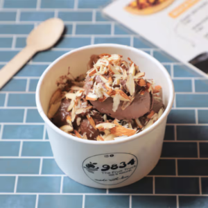 "A delicious sundae topped with scoops of ice cream, drizzled with chocolate syrup, whipped cream, and colorful sprinkles, served in a glass dish." "A delicious sundae topped with scoops of ice cream, drizzled with chocolate syrup, whipped cream, and colorful sprinkles, served in a glass dish."
