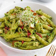 "A plate of creamy pasta topped with fresh herbs, grated cheese, and a rich sauce, served in a beautifully arranged dish."